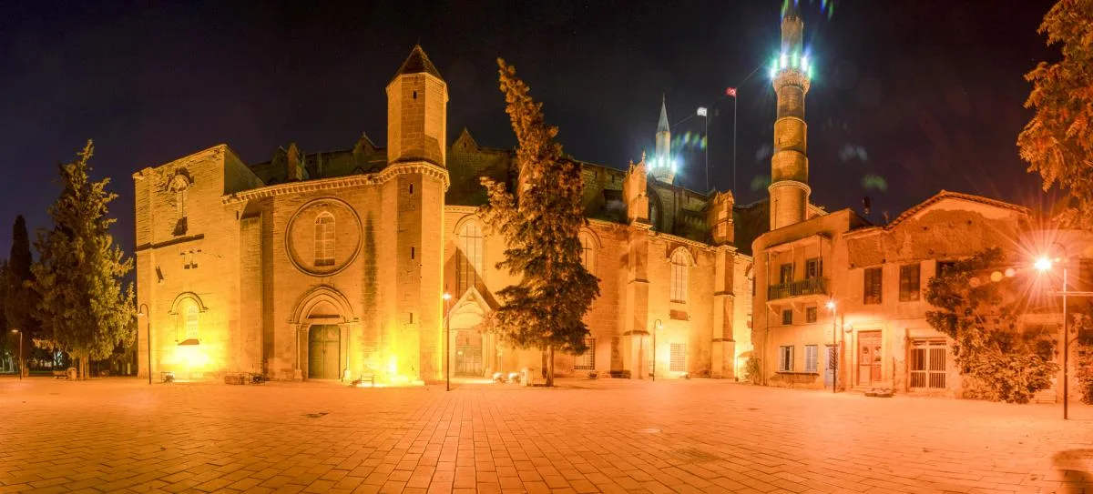 Selimiye Square at night, with the floodlit Gothic facade and minarets of Selimiye Mosque in the walled city of Nicosia